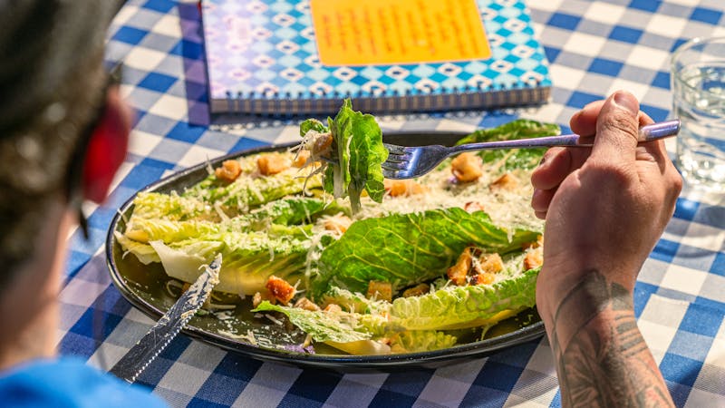 Fresh Caesar salad with croutons and parmesan shavings